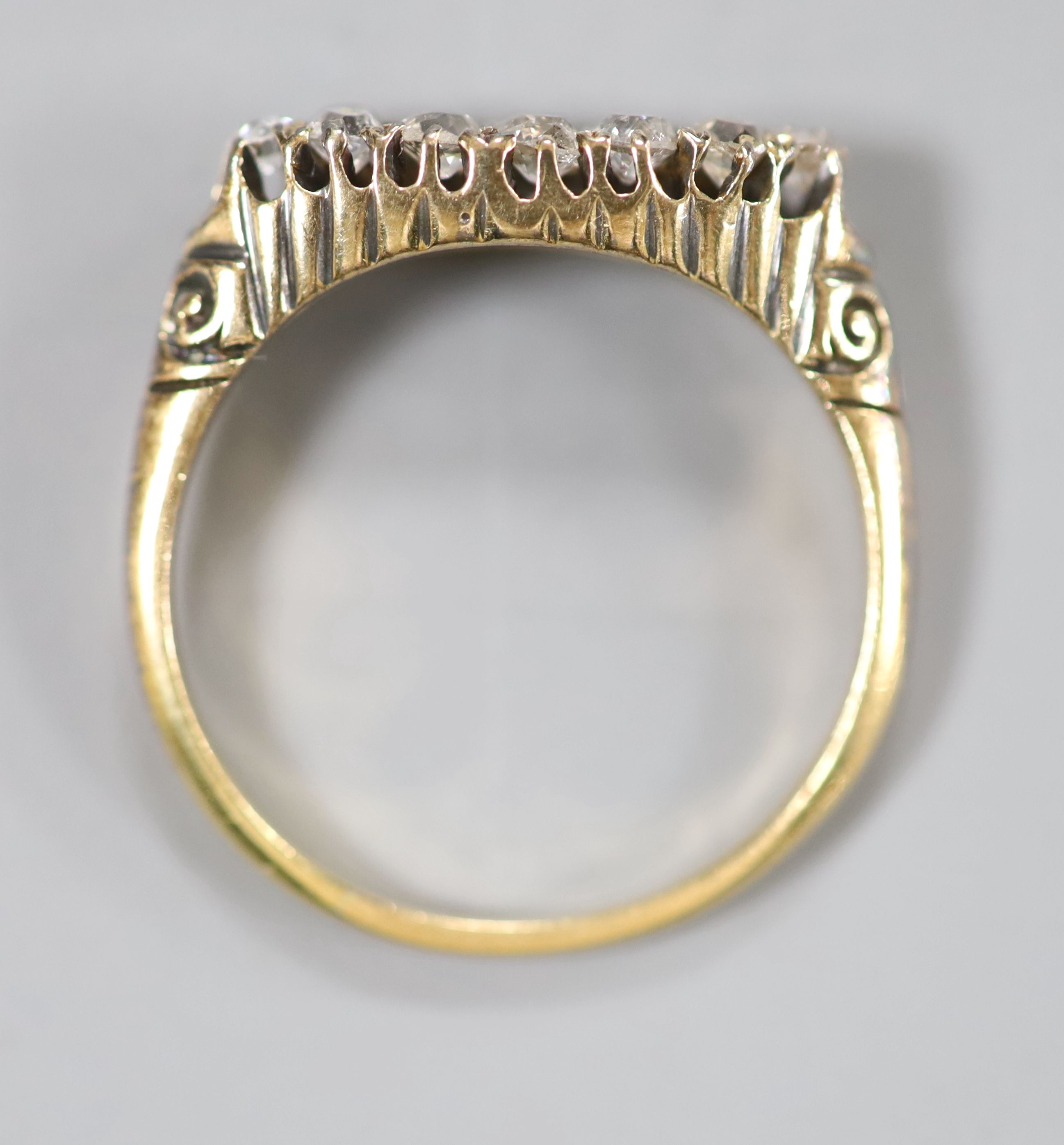 A yellow metal and two row twelve stone diamond set dress ring, size P, gross 2.6 grams.